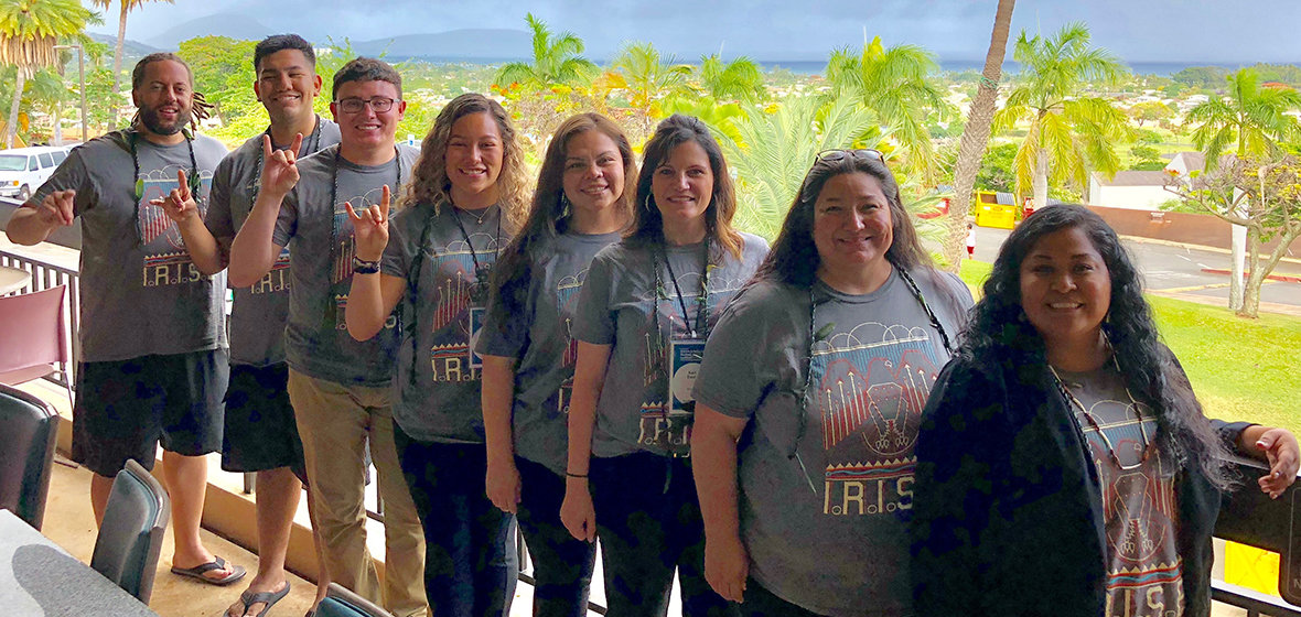 Students and faculty pose for a photo at a conference in Hawaii. 