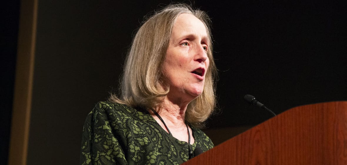 Woman speaks at a podium.