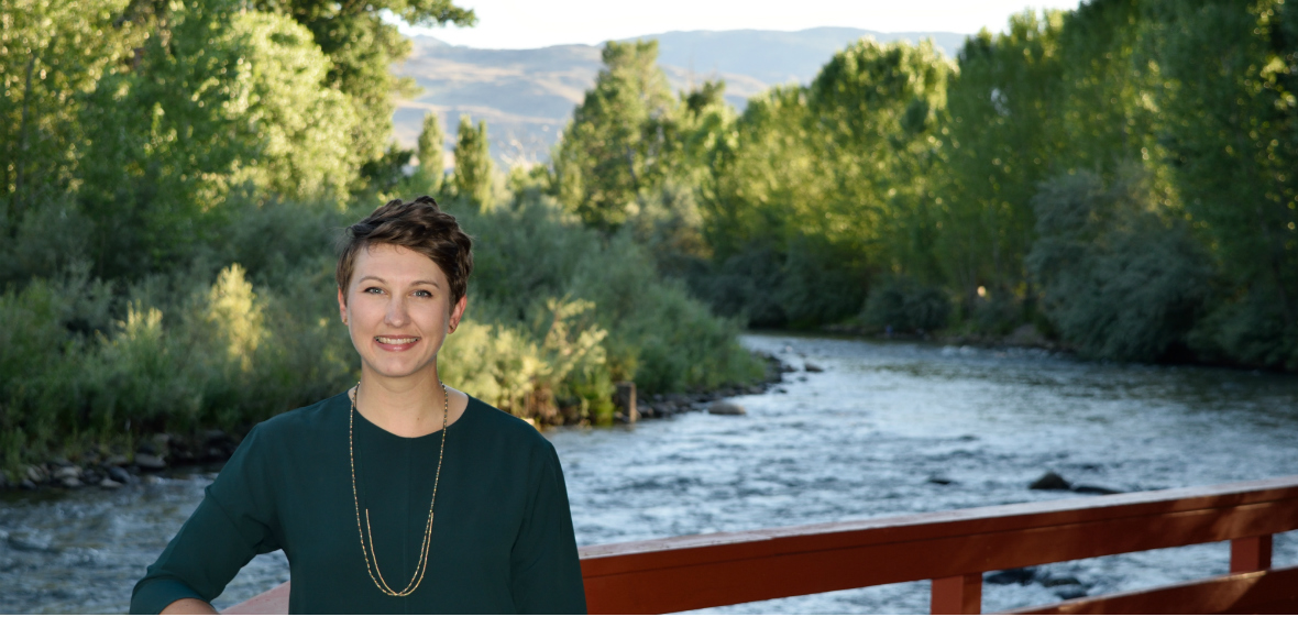 Elizabeth Koebele stands next to river