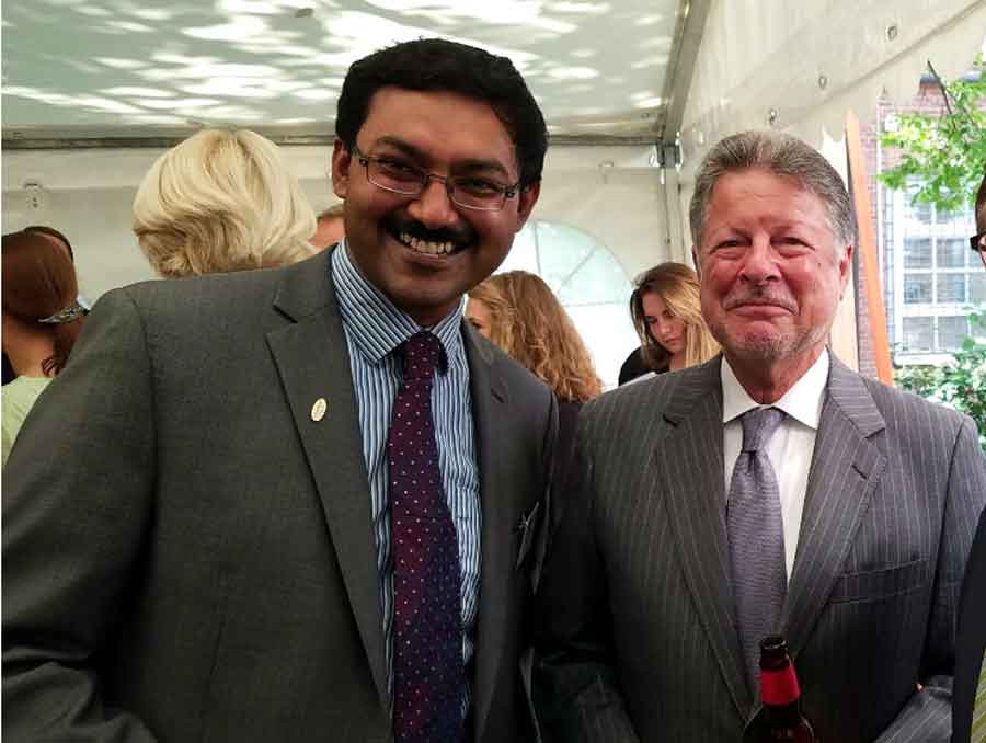 Subramanian with Fulbright Ambassador Charles C. Adams, Jr., smiling for the camera at an awards reception.