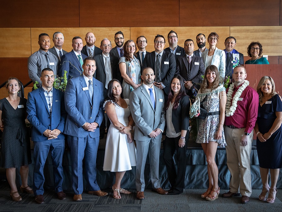 The EMBA program's 2019 graduates lined up in two rows and dressed nicely for the photo oppotunity