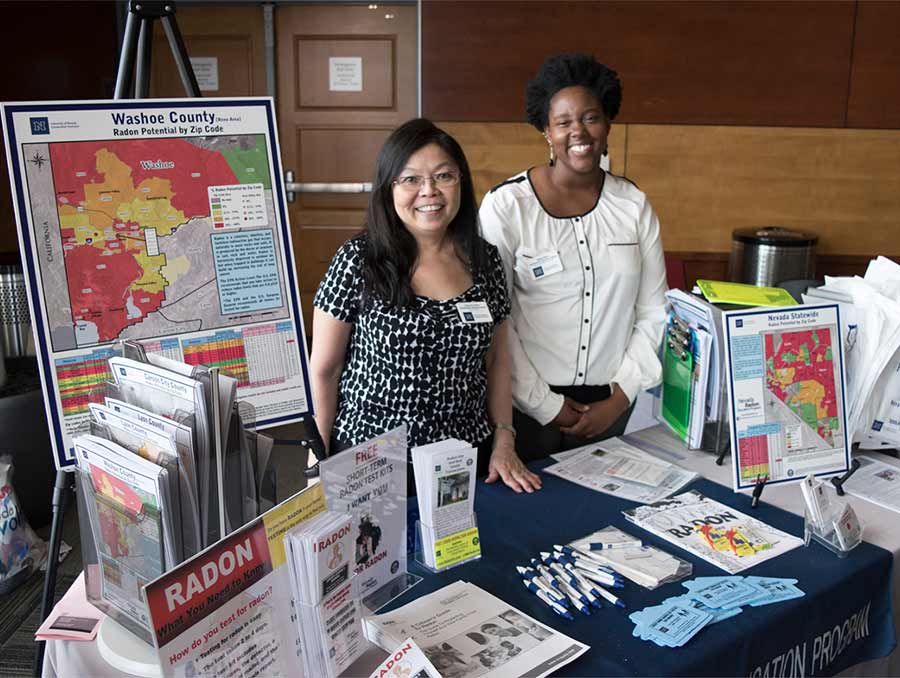 Susan Howe and Nadia Noel standing in front of Radon information table