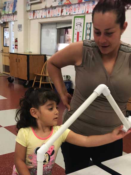 Mother and child building a model house using PVC pipe