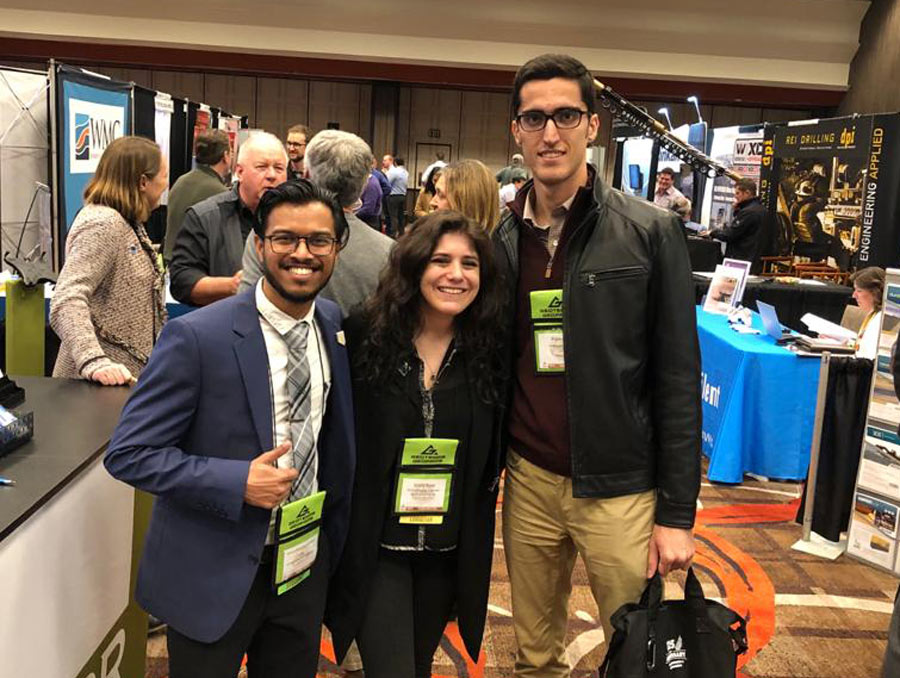 Himesh Patel (left) stands with Society of Mining Engineers Young Leaders Emily Rose and Bijan Peik.