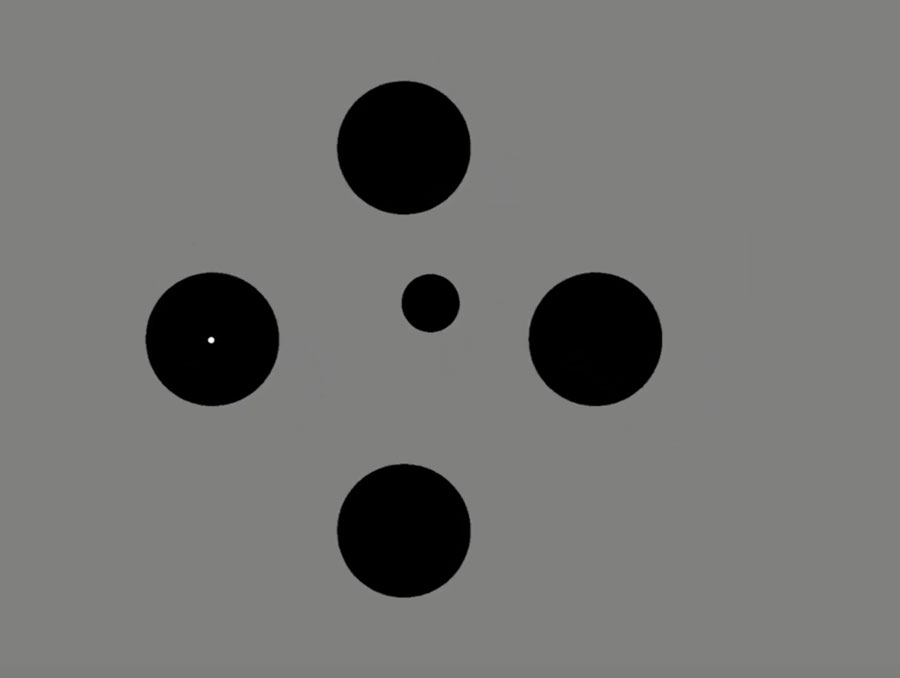 Four larger black dots surrounding a smaller black dot with a smaller white dot in the center.