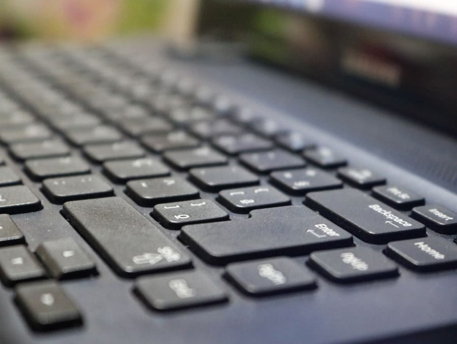 A close-up view of a black laptop keyboard. 
