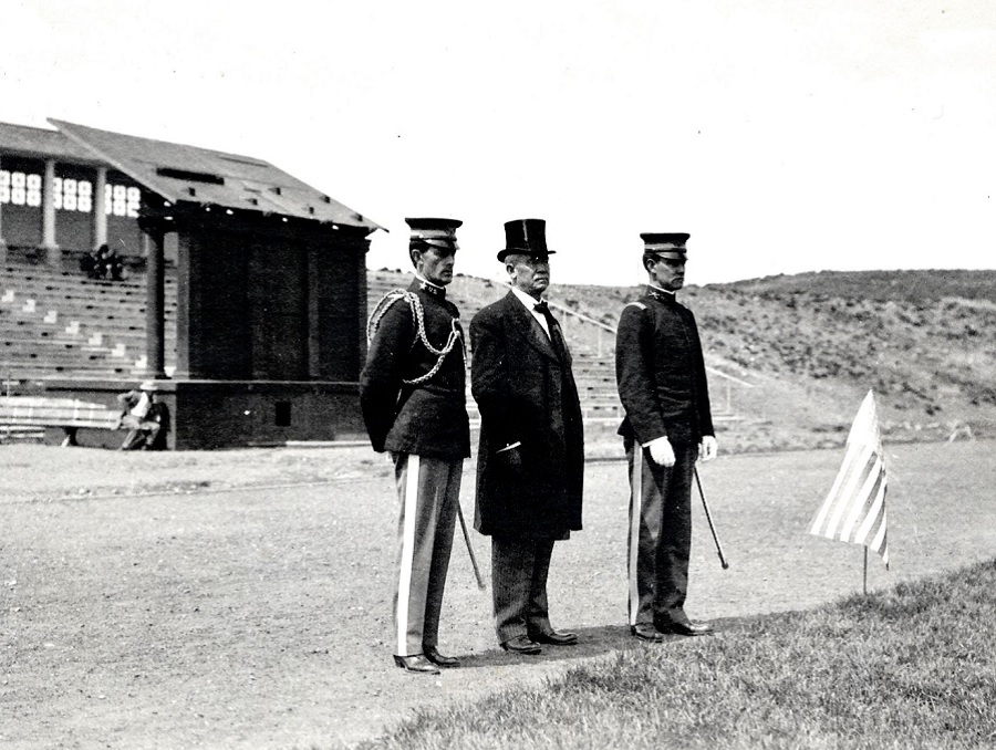 Third president of the university, University President Joseph Edward Stubbs (president from 1894-1914) stands on Mackay Field with two other men in military uniforms.