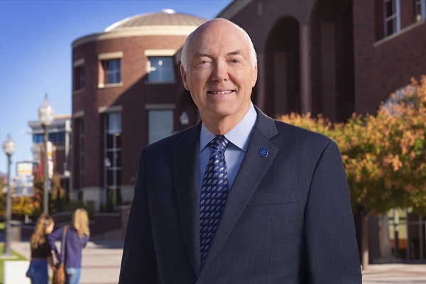 University President Marc Johnson stands in front of the Mathewson-IGT Knowledge Center.