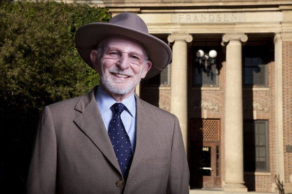 University President Dr. Milton Glick (president from 2006-2011) wears his signature hat in front of Frandsen Humanities for an issue of Nevada Silver & Blue.