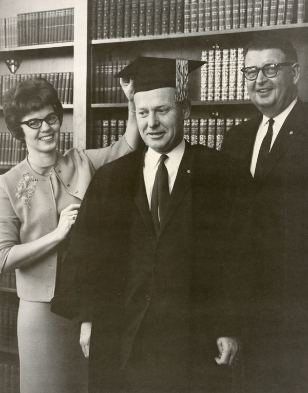 Dr. N. Edd Miller (president from 1966-1974) poses in academic attire during his induction ceremony as the new University President with recent University President Charles Armstrong (president from 1958-1966) and an unidentified woman alongside him.