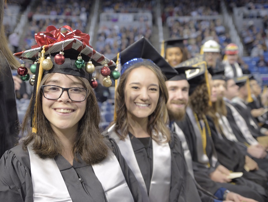 Graduates smiling at the 2019 Winter Commencement – 