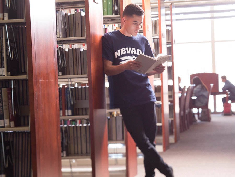 Student reading a book in the Knowledge Center