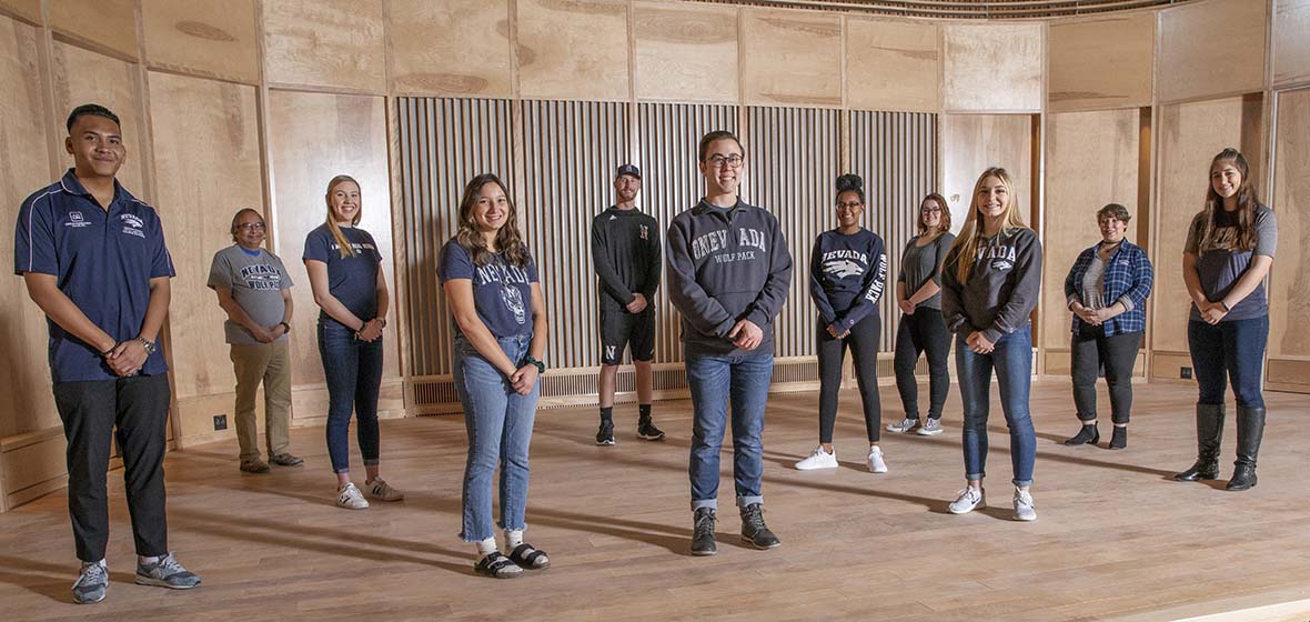 Students stand on the stage in the Harlan O. & Barbara R. Hall Recital Hall