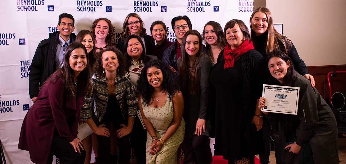 A group of people smile for the camera. 