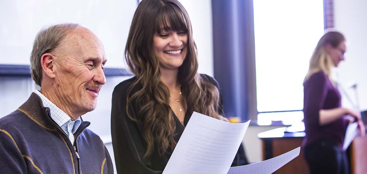 University of Nevada, Reno Professor Eric Albers and student look over paperwork from an in-class assignment. 