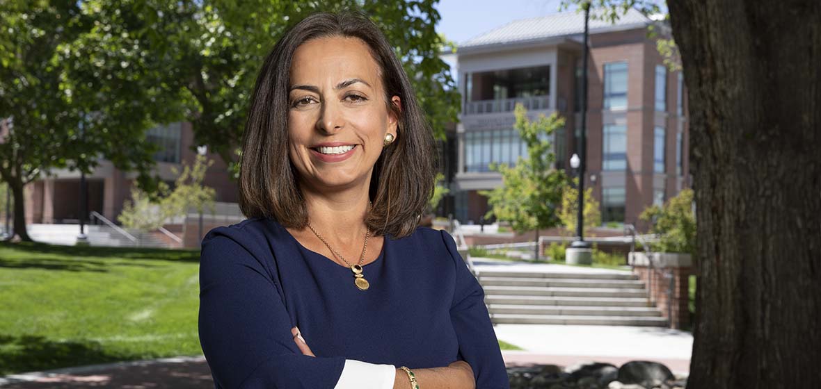 Shadi Martin poses for a photo on the University of Nevada, Reno campus with the Pennington Student Achievement Center behind her.