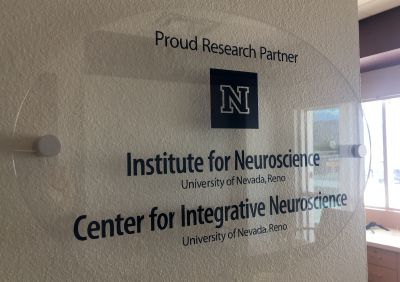 Sign on wall indicates partnership between Renown and University's neuroscience programs