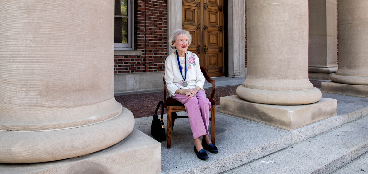 Margery McNight Carr sitting on the steps of the Mackay Mines building.