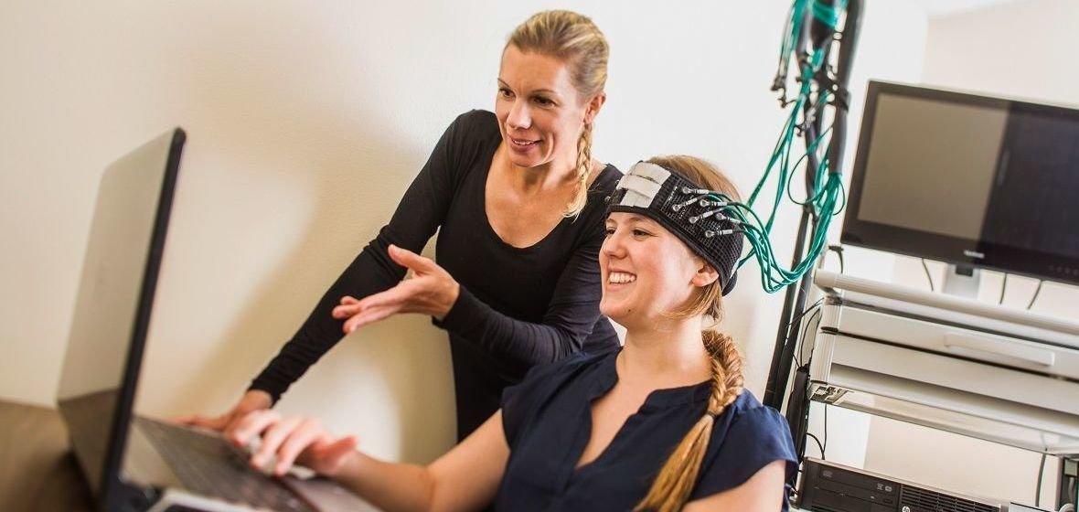Dr. Snow conducts neuroscience research with a student on campus.