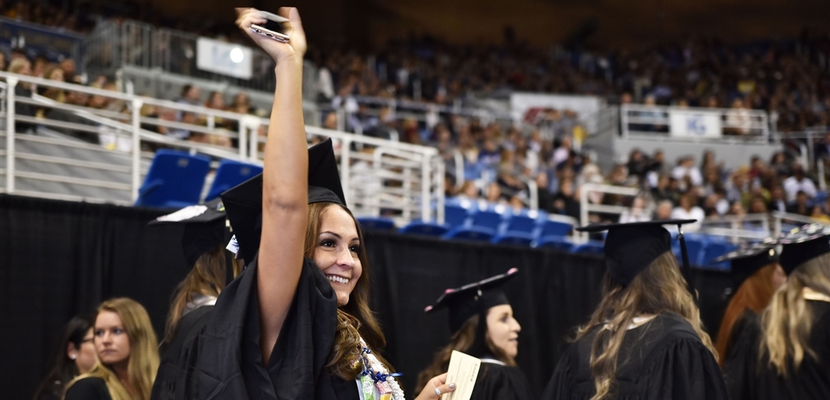 Happy graduate waving