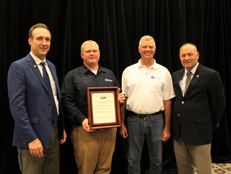 Members of the Professional Grounds Management Society stand on either side of University of Nevada, Reno Grounds Supervisors Travis Christiansen, second from the left, and Jeff Twedt, second from the right, who accepted the award, along with Grounds Maintenance Worker Jon Cady