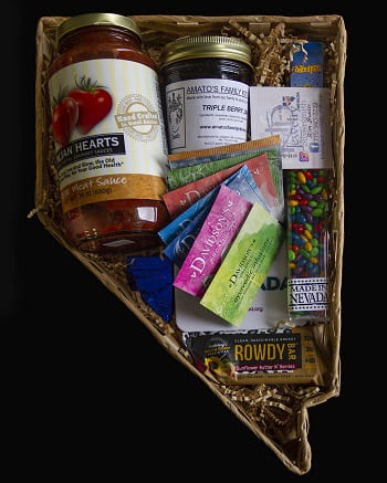 A gift basket shaped like the state of Nevada with local business products such as pasta sauce, tea, fruit preserves, and candy