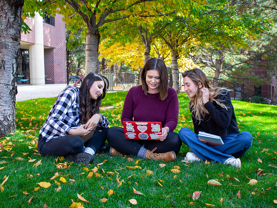 Libby Rianda, Mackenzie Kent, and Julia Matossitting on Quad