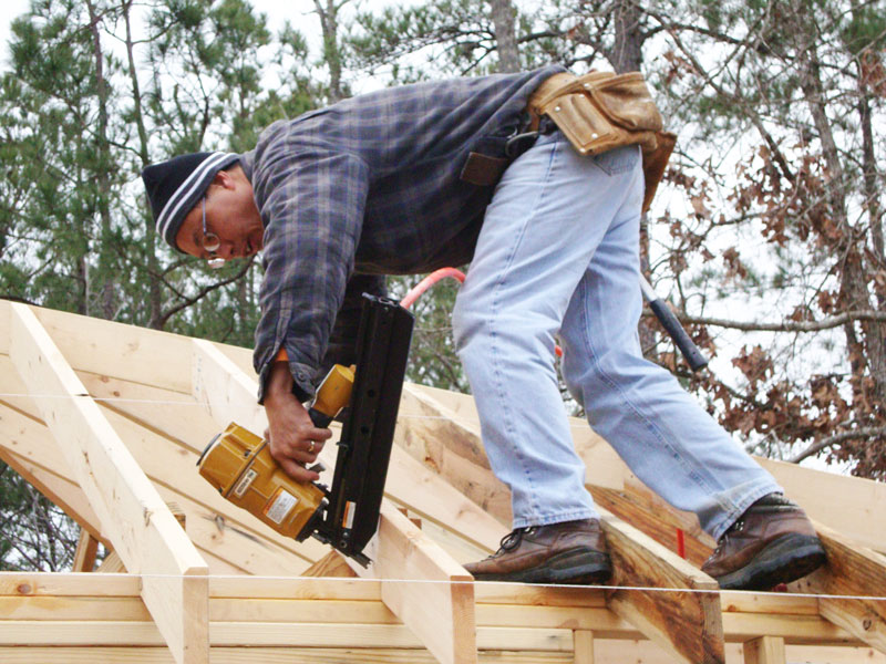 Tin Yau Tam working on the roof of a house under construction.