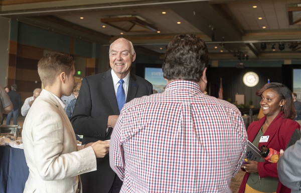 President Marc Johnson chats with campus constituents