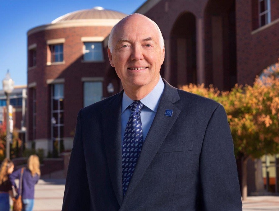 President Marc Johnson stand in front of the Knowledge Center