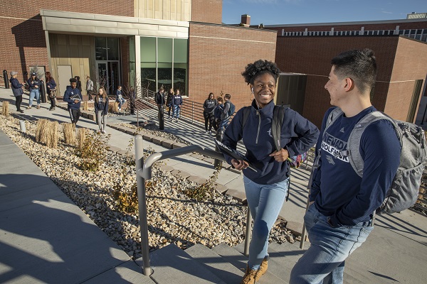 Students walking and hanging out around the new University Arts Building