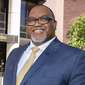 Donald Easton-Brooks smiling for a photo outside the College of Education