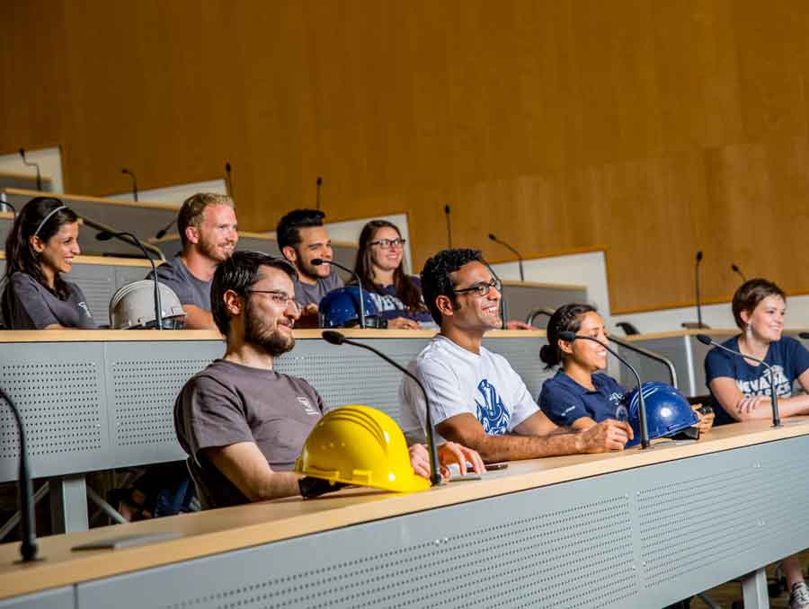 A group of students sitting in a lecture hall. 