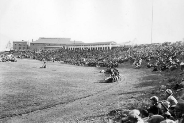 Photograph of spectators sitting around Mackay Field during Nevada's Homecoming football game against St. Mary's University in 1926.