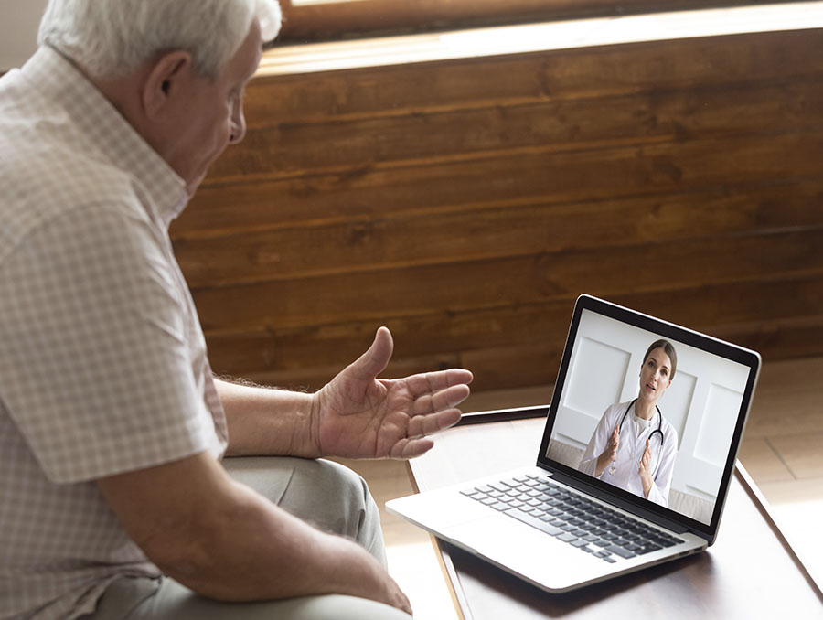 A patient and his health care provider are pictured during a telehealth consultation.