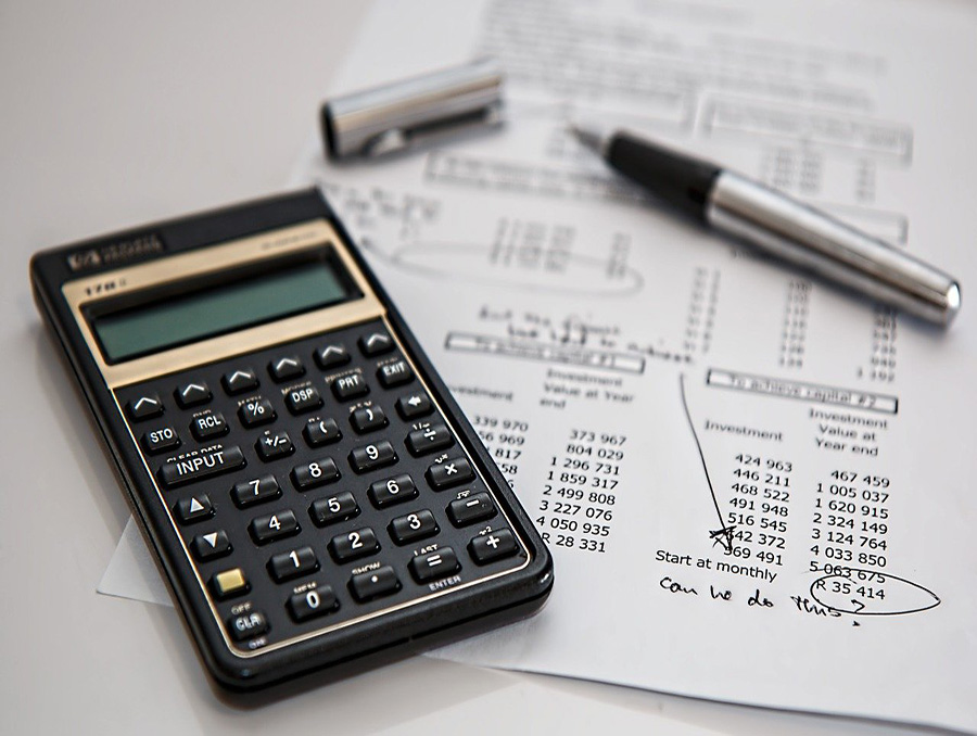 Calculator and tax documents on table.