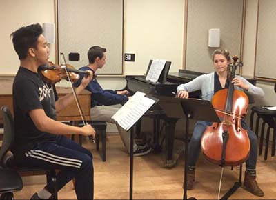 Kara Bainter in her Piano trio rehearsal with Manny Orozco (violin) and Raymond Passe (piano).
