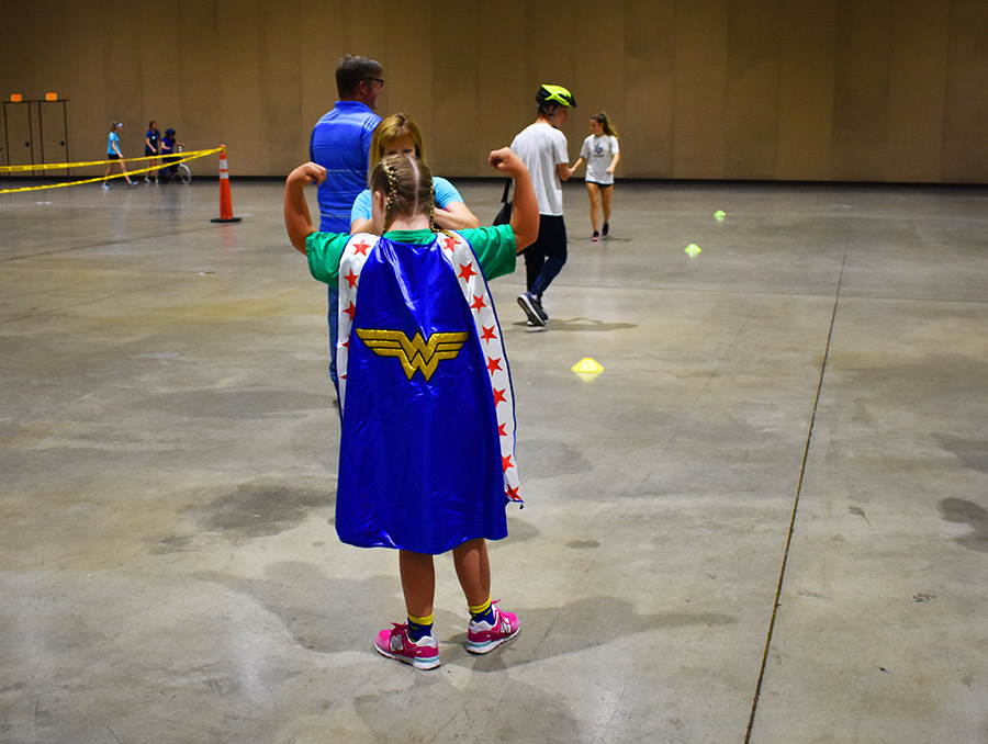 Young women pointing to a cape facing away from the camera