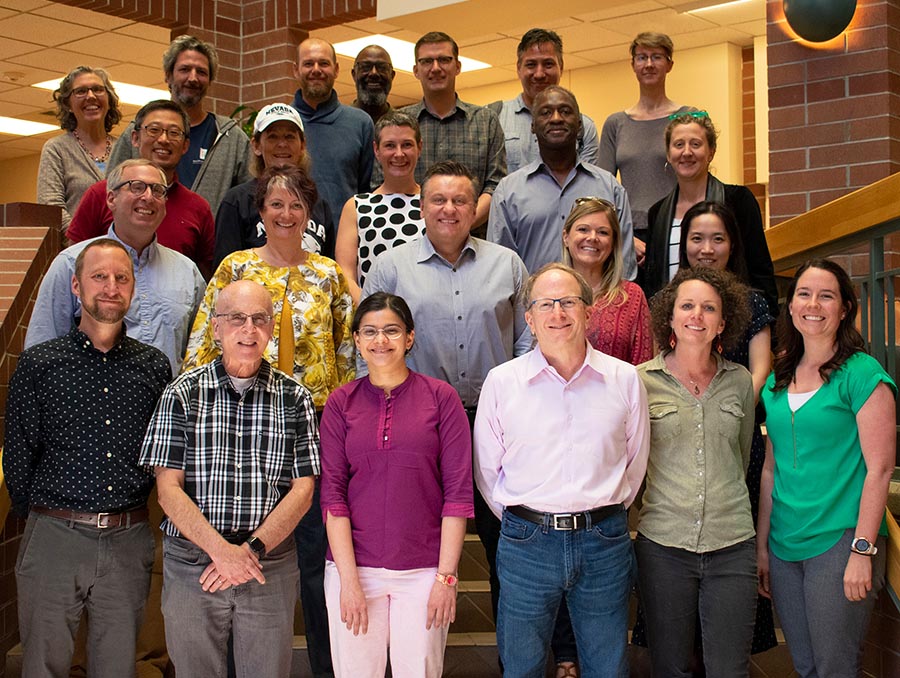 Reynolds School of Journalism faculty pose in the school's atrium.