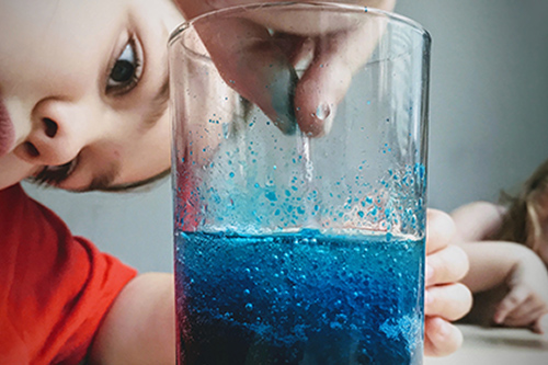 Student looking into a beaker 