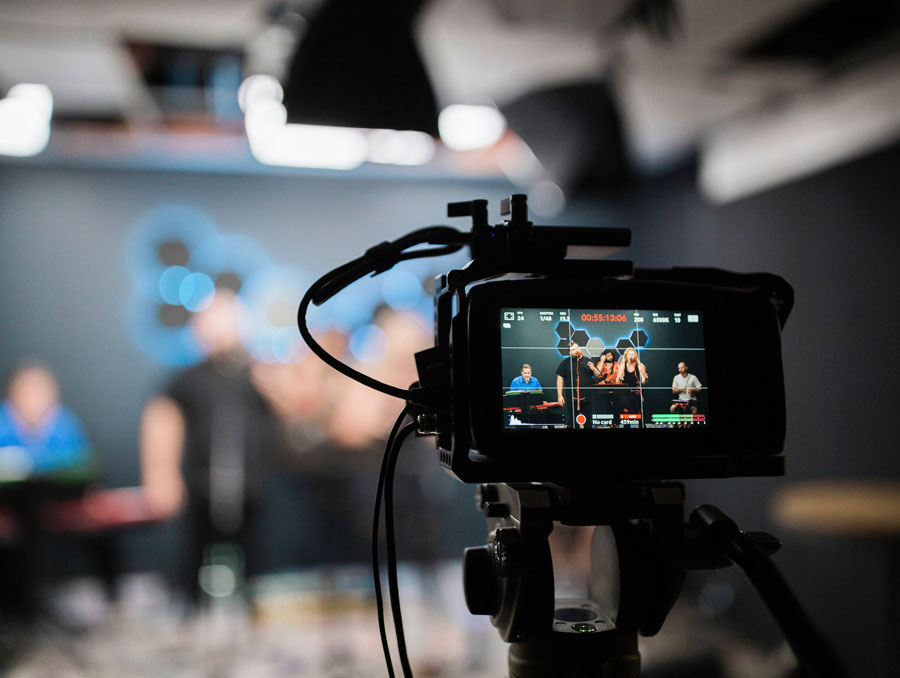 camera pointing at people in a studio