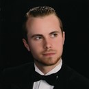 portrait of a young man wearing a black tuxedo