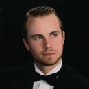 portrait of a young man wearing a black tuxedo