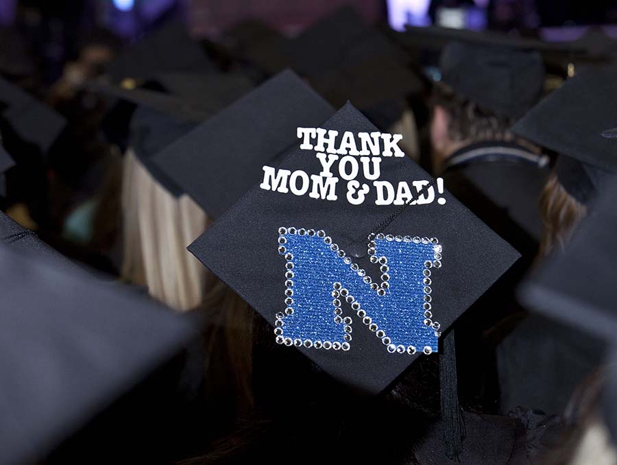 A black graduation cap with the words "Thank you Mom & Dad!" on the mortar board.