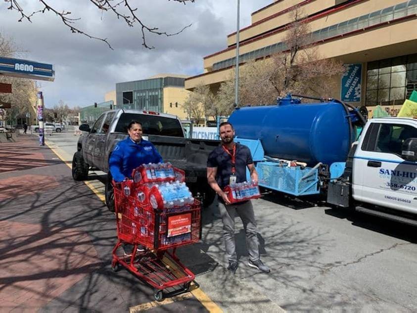 Austin Pollard carrying pallets of water