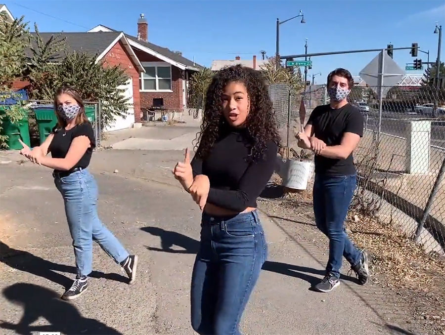 Jasmine Johnson, Kennedy Gaskins and Cam Mauer film the “Bruised and Brave” performance outside on street