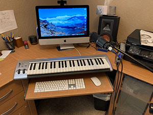 Keyboard on desk in front of computer screen