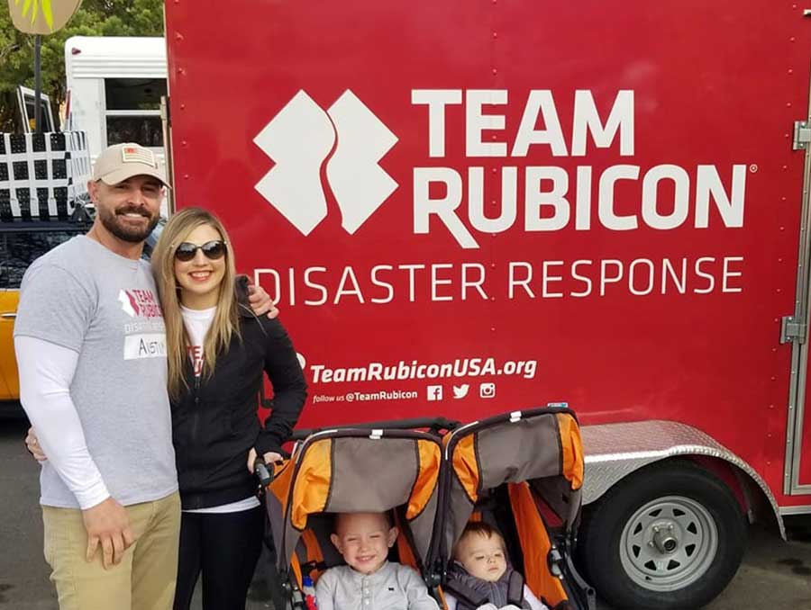 Austin Pollard in front of the Team Rubicon truck when volunteering for North Carolina the disaster relief program