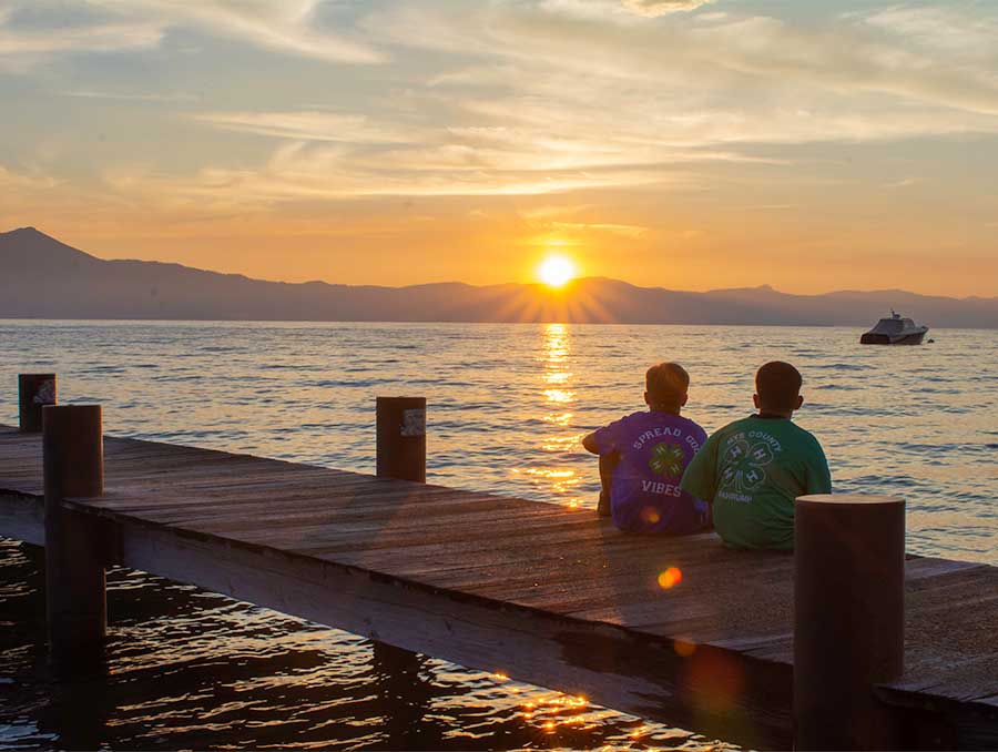 4-H'ers sitting on the dock at 4-H Camp in Lake Tahoe, enjoying the sunset