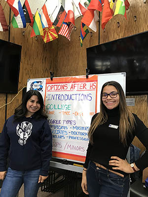 Zaira Diaz Rosas and Nayeli Robles are student mentors posing in front of a presentation board.